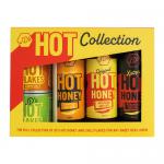 A kraft gift box holds five glass jars of JD’s Hot Honey, chutney, and condiments. Jars reveal amber honey, deep red chutney and textured preserves, each with a simple label and logo, nestled in shredded paper with twine.