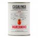 A metal can labeled Casalinga Marzanino shows glossy, elongated plum tomatoes in thick red sauce. The bright label features the brand name and an illustrated cluster of tomatoes against a warm yellow background; the can sits on a neutral surface with soft lighting. A light sheen and tiny juice drop.