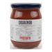 Six 500g glass jars of smooth red tomato passata sit in a cardboard tray. Each jar reveals a velvety puree with basil leaves floating near the surface. Paper labels read Casalinga; metal lids reflect light, and the arrangement shows uniformity and color contrast.