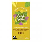 Matte dark-blue wrapper features bold gold lettering and a pale lemon slice illustration alongside green cardamom pods. A window reveals a bar studded with mixed seeds and flecks of citrus peel. Clean typography and organic-style graphics create an artisanal, natural look. Subtle grainy finish warm.
