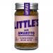 A compact 50g Little’s Café Amaretto Flavour instant coffee jar sits on a neutral surface. The label shows the Little’s logo, amaretto imagery and coffee beans in warm brown and gold tones, while a screw-top lid seals the jar.