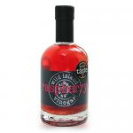 Image shows a pack of six slender glass bottles filled with deep raspberry-red vinegar, snug in a simple cardboard carrier. Each bottle bears a clean label with raspberry illustration and brand text, metal caps glinting. Warm light casts soft reflections and a faint shadow.