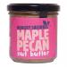 Six 180g glass jars stand in two rows, revealing a glossy maple-pecan spread. Each jar wears a cream label with a playful squirrel logo, maple leaf and pecan illustrations. Gold screw lids catch light; jars sit on a pale surface against a soft, neutral background. Soft light forms faint warm shadows.