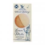 A photo shows a packet of Island Bakery Lemon Melts beside a neat pile of small, round pale-yellow biscuits dusted with powdered sugar. The wrapper displays bright lemon artwork and the bakery logo, on a light wooden surface with soft natural light.