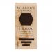 A photo shows round charcoal wafers with matte black-gray surfaces and delicate crumbly edges. A simple kraft sleeve with a minimalist bakery label and clear window reveals six biscuits. Soft side light emphasizes texture, crumbs, and a faint dusting of flour.