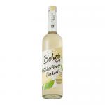 Six clear glass bottles of Belvoir Fruit Farms Elderflower Cordial (500ml) stand closely together, filled with pale straw liquid. Each has a cream botanical label with elderflower illustrations and green branding; metal screw caps top the uniform row against a plain background. Soft lighting accents