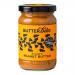 Six jars of Butter Bike Co Rugged Peanut Butter (285g) sit on a wooden board. Labels display a bold logo and rustic typography. Matte black lids cap the jars. One jar is open, revealing thick, textured peanut butter with a spoon inside; scattered peanuts and crumbs surround them.