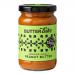 A pack of six 285g Butter Bike Co Smoked Chilli Peanut Butter jars stands in a neat row. Clear glass reveals rich reddish-brown spread; cream labels display the brand logo and chilli illustration, while dark lids catch studio light against a plain backdrop.