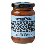 A photo shows six 285g Butter Bike Co jars of Dark Chocolate Peanut Butter spread arranged in two rows. Each clear jar reveals glossy, dark brown spread with a gentle swirl; labels feature the brand logo, chocolate accents and peanut illustrations against a neutral background. With soft reflections.