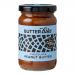 A photo shows six 285g Butter Bike Co jars of Dark Chocolate Peanut Butter spread arranged in two rows. Each clear jar reveals glossy, dark brown spread with a gentle swirl; labels feature the brand logo, chocolate accents and peanut illustrations against a neutral background. With soft reflections.