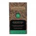 A matte black wrapper of Chocolarder Ashaninka 70% Dark sits centered on a neutral background. Gold lettering and a simple indigenous-inspired emblem contrast with deep-brown chocolate squares peeking from an open edge, scattering a few cocoa nibs nearby. Warm highlights accent gentle ridges nearby.