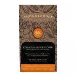 A rectangular box contains ten individually wrapped 50% milk chocolate squares studded with golden honeycomb pieces. One square breaks open to show a crunchy, aerated honeycomb center. The image highlights warm milk-brown and amber tones with a clean logo on the front.