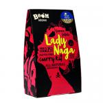 Image shows glossy red-and-yellow snack packets arranged in a neat stack. Each packet displays a bold Boom Kitchen logo and a stylized lady-naga illustration, clear product name lettering, small icons, and a tiny transparent window revealing crisp, textured pieces inside.