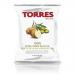 A display shows twenty slim 40g packets of Torres Extra Virgin Olive Oil crisps arranged in neat rows. Each green packet features the Torres logo, golden crisp images and olive branch graphics. Light reflects on the glossy packaging, highlighting product text and texture. Subtle sheen accents edges.