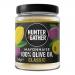 A studio photo shows a 240g jar of Hunter & Gather Classic Olive Oil Mayonnaise beside six small Hunter & Gather chutney and condiment jars arranged in a neat row. Labels show minimalist branding in green, cream and black; jars sit on a pale surface under soft, even lighting Crisp glass reflections