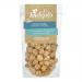 A glossy pouch of Joe & Seph’s Vegan Salted Caramel Popcorn sits against a pale backdrop. Warm amber caramel coats irregularly popped kernels, showing glistening crystals of salt. The brand logo appears center on the bag, with vegan labeling and golden accents. Soft matte backdrop and soft lighting.