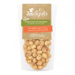 A small sealed bag with Joe & Seph’s branding in bold type. The front shows glossy toffee-coated popcorn, red apple slices and cinnamon sticks illustrated against a warm, rustic background. The product name and vegan label appear on the pack.