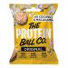 A matte pouch displays The Protein Ball Co logo on a turquoise band. The front shows three coconut-dusted golden-brown balls beside halved macadamias and scattered shredded coconut. Clean white background and simple sans-serif typography create a fresh, tropical presentation. Soft shadows add depth.