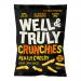 Bright rectangular pack displays the Well&Truly logo across the top in bold green lettering. A photograph shows golden cheese sticks clustered beside a small wedge of cheese. White background with green accent banners, product name and weight (100g) printed clearly on the front. Small icons along base.