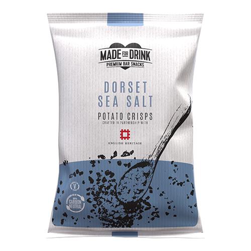 A photo shows a box of slim pale-blue snack packets labeled Made For Drink English Heritage Dorset Sea Salt. Each 40g bag sits upright in neat rows, packet fronts showing coastal illustrations, scattered salt flakes and crisp imagery, forming a 24-pack display Soft coastal hues and clean typography