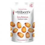 A glossy photo shows a neat stack of 15 bright orange 40g packs of Mr Filberts Crunchy Corn Barbecue, each bag displaying bold logo, corn graphic and barbecue imagery. Packs align in rows against a plain white background with soft studio lighting. Crimped seals, tiny icons and rear text are legible.