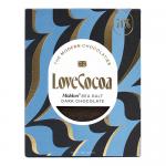 Image shows twelve 70g dark chocolate bars wrapped in sleek, deep-hued packaging featuring the Love Cocoa logo and product name. Bars are arranged in a tidy grid, some angled to reveal textured chocolate squares and sprinkled Maldon sea salt flakes on the surface subtle studio light & soft shadows.