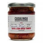 A clear glass jar shows chunky, dark-olive and sun-dried tomato tapenade with visible flecks of herbs and oil. A simple label around the jar displays the Casalinga brand and product name and the 190g weight; a metal lid seals the jar against a plain background.