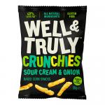 Bright green and white multipack sits against a plain background, displaying the Well&Truly logo and bold 'Crunchy Sour Cream & Onion Sticks' text. A pile of golden, ridged snack sticks and a small bowl of pale sour cream with chopped chives appear beside scattered herb flecks. Pack shows ten sticks