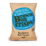 Photo shows ten kraft-paper bags arranged in a neat grid, each labeled Brown Bag Crisps with Sea Salt & Malt Vinegar text and a green logo. Wrinkled brown packaging contrasts with bright yellow crisps illustrated on the front, with salt crystals and vinegar droplets. Soft lighting highlights texture