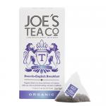 Six compact boxes of Joe's Tea Co. Ever-So-English Breakfast Organic stand aligned on a grocery shelf. Cream and navy packaging displays a vintage teacup illustration, refined typography and an organic seal, with soft floral motifs and subtle texture. Soft highlights add calm visual balance subtly..