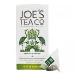 Photo shows a 6-pack of Joe's Tea Co. 'Queen of Green' organic tea boxes arranged in two rows of three. Each slim green box features stylized tea leaves, white accents, and clean serif branding. Soft lighting casts gentle shadows on a plain white background. Visible printed details and soft texture.