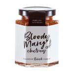 Glass jar of Hawkshead Relish Bloody Mary Chutney sits upright, revealing chunky red and orange chutney flecked with herbs and spices. A cream label with bold black logo and red accents wraps the jar. Light reflects on the jar, and a neutral background frames it. Highlights rim the glass and labels.
