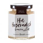 Six clear glass bottles of Hawkshead Relish Hot Horseradish Sauce sit on a white surface. The creamy pale sauce shows through red-and-white labels with the brand name; black caps and soft studio lighting cast gentle shadows.