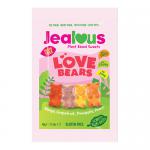 Vibrant impulse bags line up, each glossy magenta packet sporting heart motifs and bold white 'Jealous' lettering. A clear window reveals pastel, heart-shaped sugar-free gummy bears in pink, red and cream, scattered across a soft reflective surface under bright, even light. Soft shadows fall. Nearby