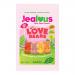 Vibrant impulse bags line up, each glossy magenta packet sporting heart motifs and bold white 'Jealous' lettering. A clear window reveals pastel, heart-shaped sugar-free gummy bears in pink, red and cream, scattered across a soft reflective surface under bright, even light. Soft shadows fall. Nearby