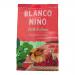 A bright green and red packet of Blanco Niño Chilli & Lime tortilla chips stands upright against a neutral background. The logo tops a vivid chilli-and-lime illustration; a clear window reveals triangular, lightly speckled chips and printed nutrition text along the base.