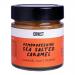 Six glass jars of CRWST Pembrokeshire Sea Salted Caramel are arranged in two rows on a neutral surface. Rich amber sauce shows through the jars. Cream labels with black lettering and coastal motifs and metal lids reflect soft studio light.