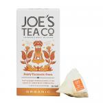 A vibrant six-pack of Joe’s Tea Co. Feisty Turmeric Guru sits as bright turmeric-yellow boxes with a bold logo and playful typography, illustrated turmeric roots and spice accents, an organic seal, arranged against a neutral background.