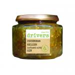 Six clear glass jars of Drivers Cucumber Relish infused with gin, 350g each, sit in a neat row. The chunky green relish shows through the glass; cream labels bear the Drivers name and simple graphics. Silver lids top each jar against a white backdrop. Soft natural lighting highlights textures. Close