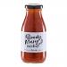 Six glass bottles of Hawkshead Relish Bloody Mary Ketchup stand on a wooden board, deep red sauce visible through clear glass. White labels show bold black and red text and a small logo. Soft natural light creates gentle highlights and subtle shadows.
