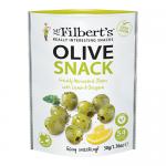 Close-up shot shows twelve small glass jars of Mr Filberts Lemon & Oregano green olives, neatly arranged. Clear labels display brand and flavor. Bright green olives float in pale brine with visible lemon slices and oregano sprigs under soft studio lighting. Soft shadow and shallow focus add texture.