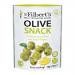 Close-up shot shows twelve small glass jars of Mr Filberts Lemon & Oregano green olives, neatly arranged. Clear labels display brand and flavor. Bright green olives float in pale brine with visible lemon slices and oregano sprigs under soft studio lighting. Soft shadow and shallow focus add texture.