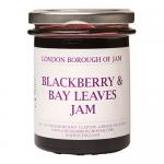 Six glass jars of deep purple blackberry and bay leaf jam sit clustered; each 220g jar shows a white label with the London Borough of Jam logo and gold lid. Ripe blackberries and green bay leaves lie beside the jars on a neutral, softly lit background. Soft sheen glints on curved glass; neat labels.
