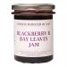 Six glass jars of deep purple blackberry and bay leaf jam sit clustered; each 220g jar shows a white label with the London Borough of Jam logo and gold lid. Ripe blackberries and green bay leaves lie beside the jars on a neutral, softly lit background. Soft sheen glints on curved glass; neat labels.