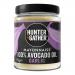 A glossy jar of Hunter & Gather garlic avocado oil mayonnaise sits center, pale creamy spread visible through clear glass, green-and-white label with brand logo. Surrounding it are six small condiment tubs with colorful lids and matching labels, arranged on a white surface.