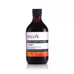 Six clear 500ml bottles of Willy’s Honey Apple Cider Vinegar sit in a simple cardboard tray. Each bottle shows amber liquid, a white and gold label with Willy’s logo, honey and apple illustrations, and a sealed cap. Lighting highlights glass reflections and label details Soft shadows accent bottles