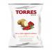 A vibrant red-orange bag of Torres Smoked Paprika Crisps sits upright, showing the bold Torres logo and a smoky paprika graphic. A clear window reveals golden, ridged crisps dusted with red seasoning; crisp shadows and sharp lighting emphasize texture and color.