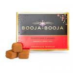 Photograph shows a neat rectangular box of eight round Booja-Booja truffles arranged in two rows. Each truffle is glossy dark chocolate with craggy honeycomb caramel centers revealed in one cut piece. Warm brown tones and subtle gold accents highlight artisanal detail. Linen liner adds subtle depth.