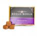 The image shows a rectangular box of Booja-Booja Deeply Chocolate truffles. Glossy dark-brown packaging features gold accents, the brand logo and product name centered, a photo of rounded chocolate truffles to one side, clear nutrition text and a small weight label at the bottom. On a white surface.