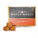 A small rectangular box sits against a white background, its matte brown sleeve featuring cream lettering. Eight round truffles peek from an open tray, each glossy dark chocolate studded with crushed hazelnut pieces and fine cocoa dust, hinting at a crunchy interior. Soft gloss catches faint sheens.